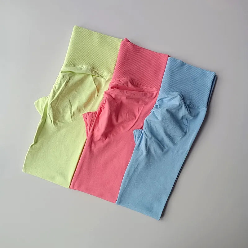 Set of quick dry sport leggings in yellow, pink, and blue for activewear enthusiasts