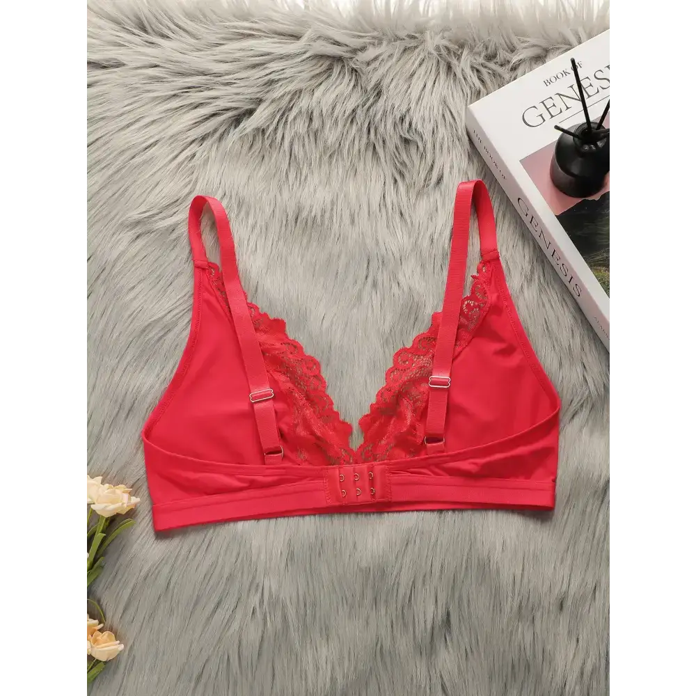 Red lace push up bra for women with adjustable straps and hook closure on a gray fur background