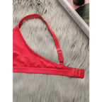 Red lace push up bra for women with adjustable straps and hook closure displayed on gray fur background