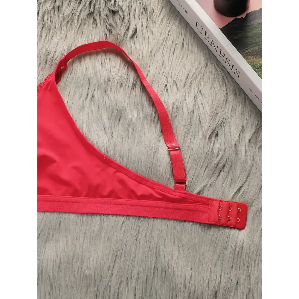Red lace push up bra for women with adjustable straps and hook closure displayed on gray fur background