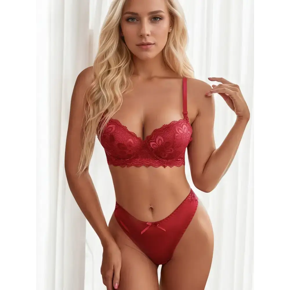 Model wearing a red two piece lace lingerie outfit with floral details and matching panties