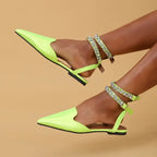 Neon green flat heel rhinestone ankle strap sandals from The Lady's Haven Boutique on model feet
