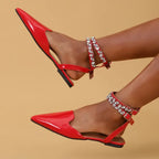 Red flat heel rhinestone ankle strap sandals with pointed toes from The Lady's Haven Boutique