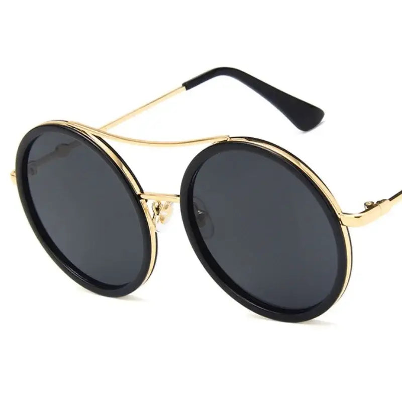 Stylish round sunglasses with designer flair featuring gold accents and dark lenses