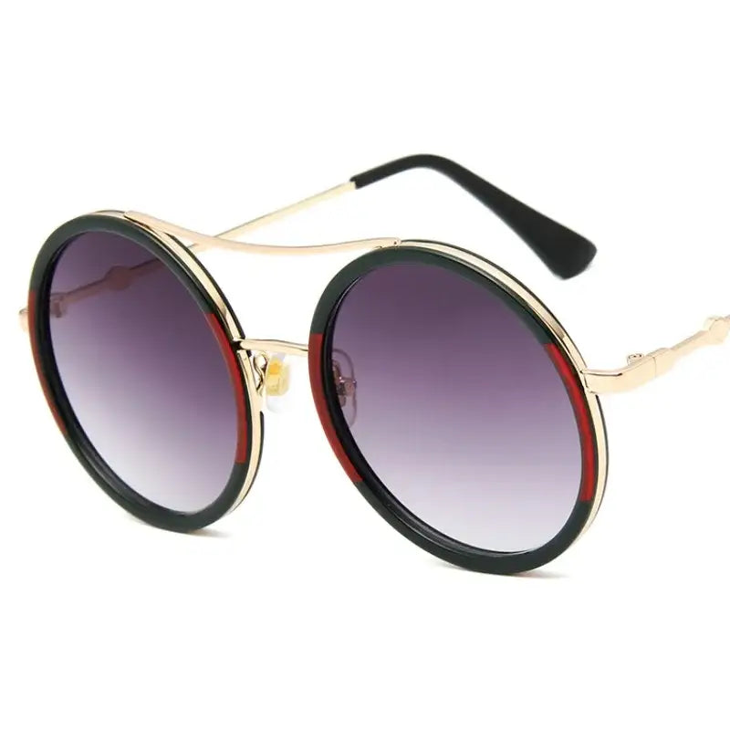 Chic round sunglasses with designer flair featuring a gold frame and gradient lenses