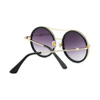Stylish round sunglasses with designer flair featuring a chic black frame and gradient lenses