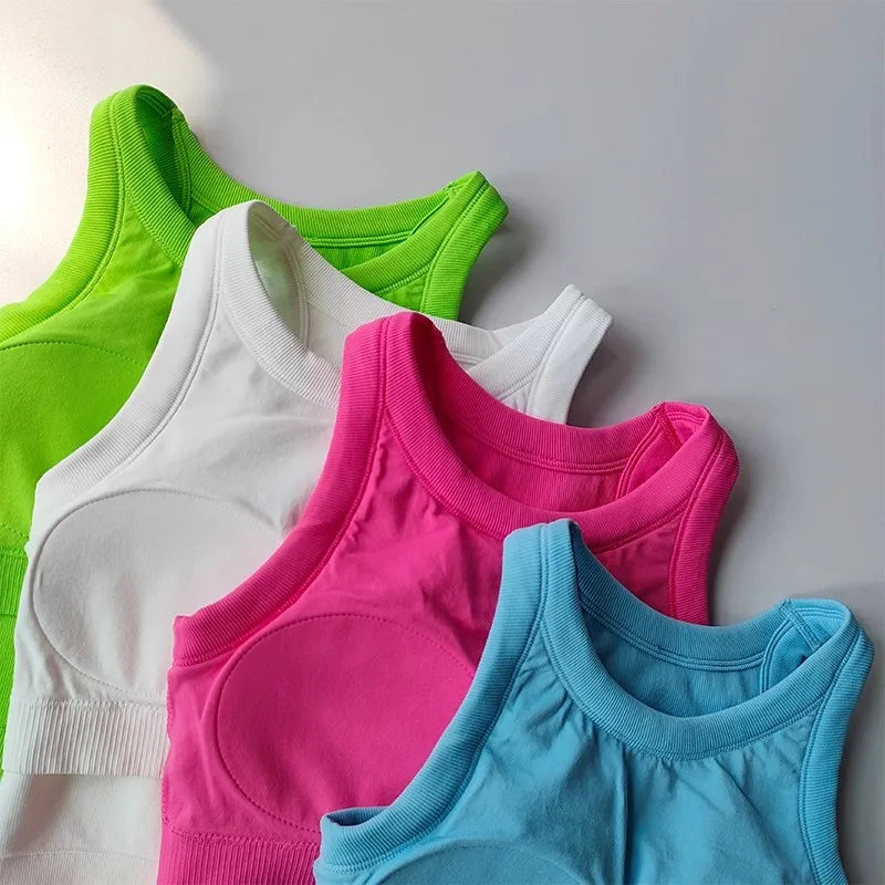 Assorted seamless sports vest for women in bright colors including green, white, pink, and blue