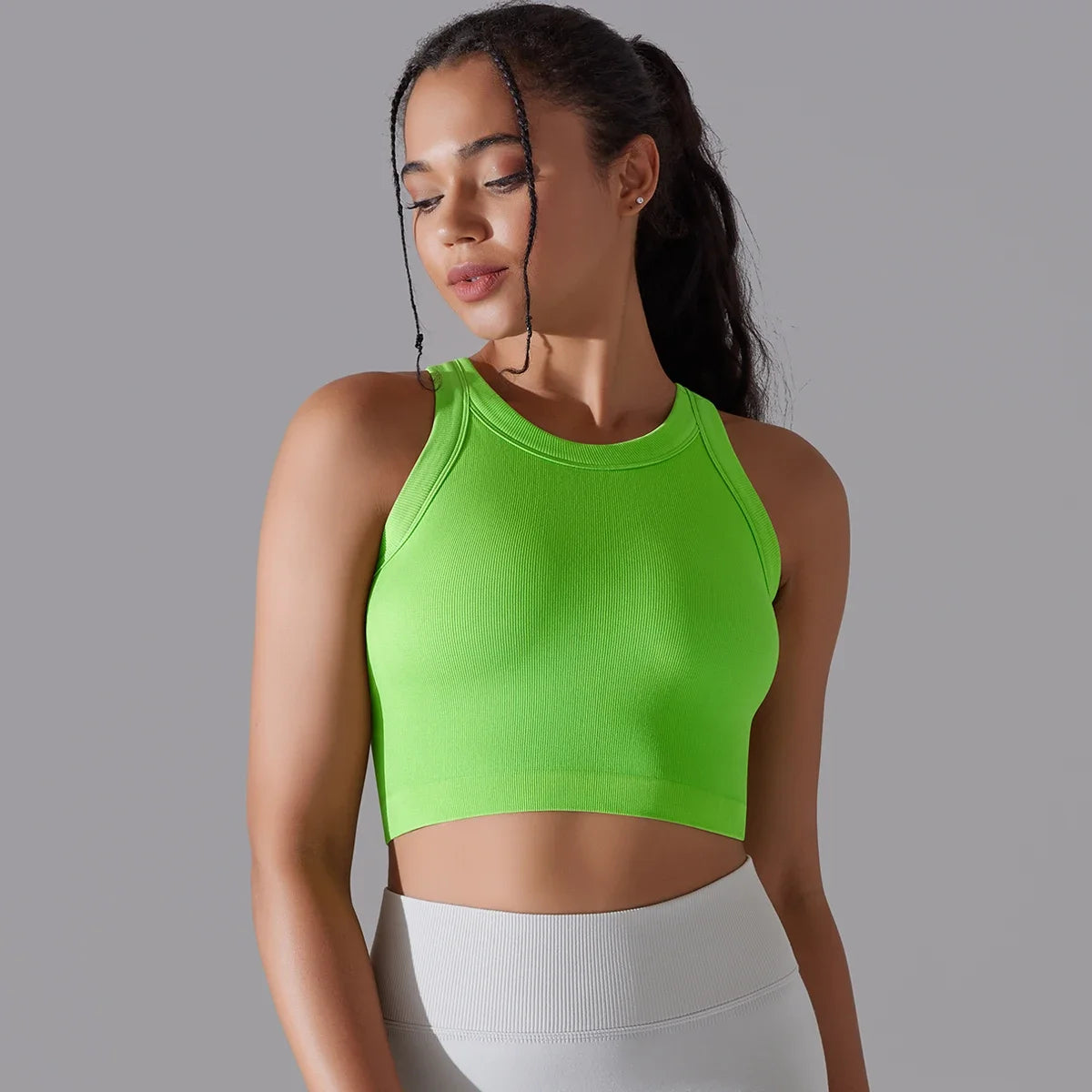 Bright green seamless sports vest for women with a fitted design and stylish crop length