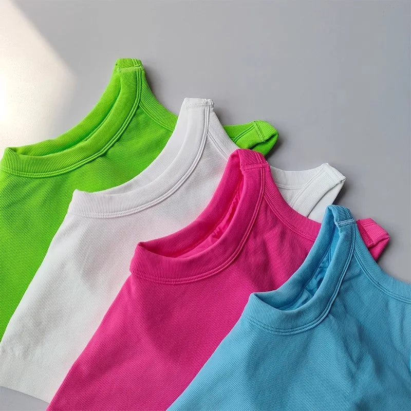 Colorful seamless sports vest for women in green, white, pink, and blue, perfect for activewear.
