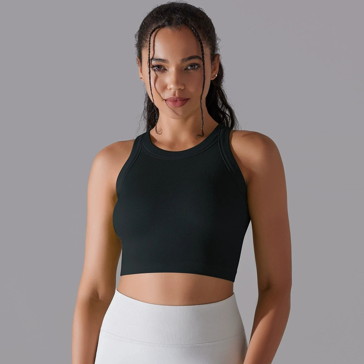 Black seamless sports vest for women with a cropped fit, ideal for workouts and casual wear
