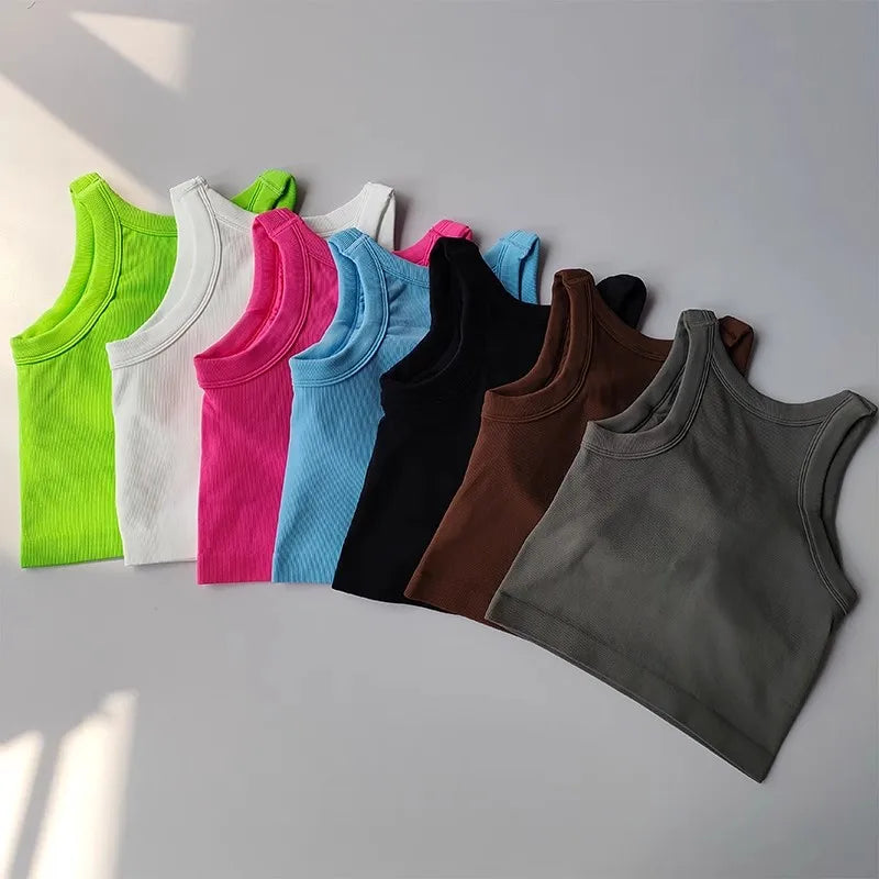 Collection of seamless sports vests for women in various colors including pink, green, and black