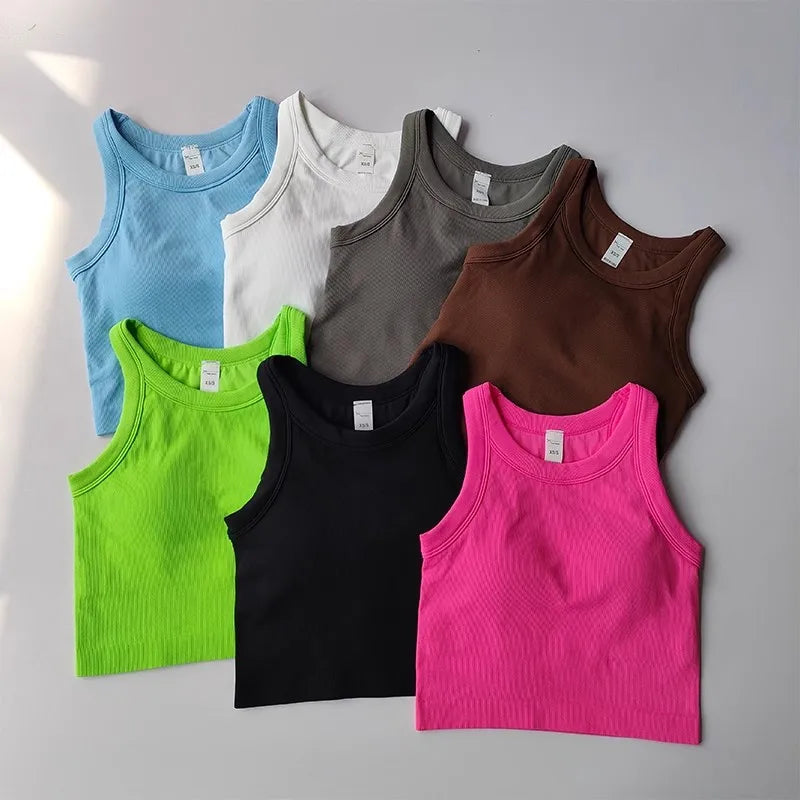 Colorful collection of seamless sports vests for women in various shades including pink, black, and green