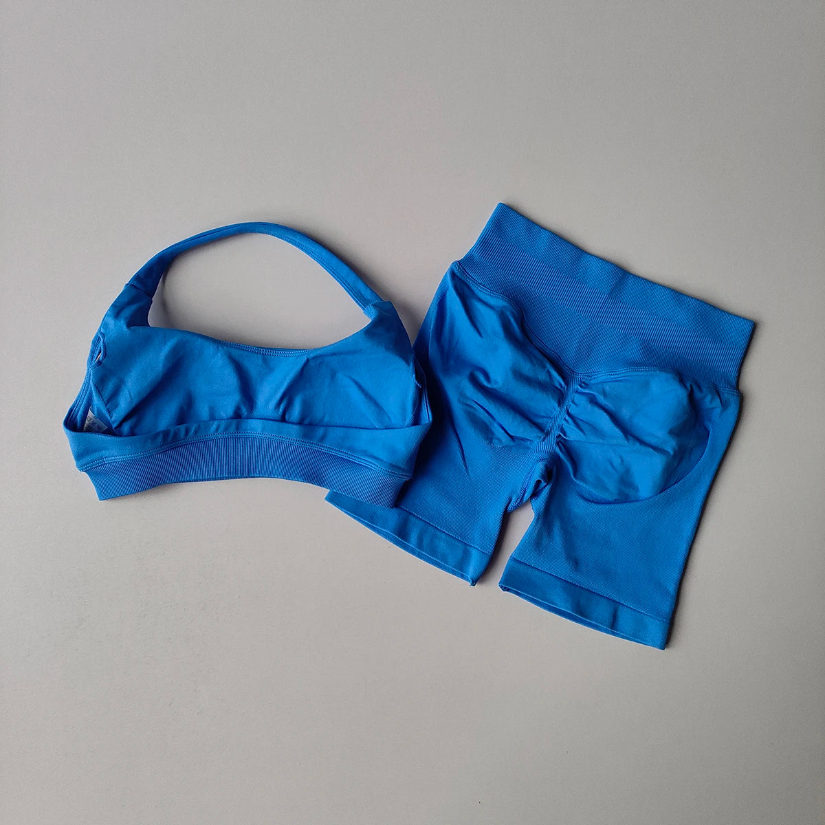 Blue seamless yoga suit for women featuring a stylish bra and matching shorts set