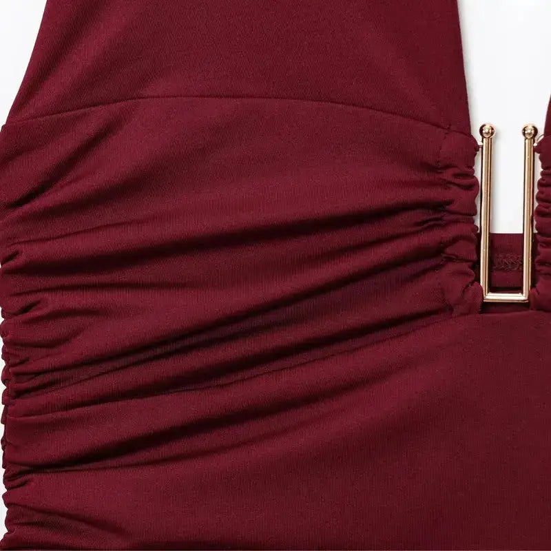 Close-up of maroon pleated off shoulder crop top with gold buckle detail from The Lady's Haven Boutique