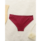 Red panties from sexy embroidered lace lingerie set by The Lady's Haven Boutique on white textured background