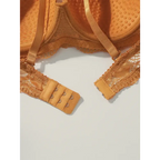 Close-up of adjustable back hooks and lace detailing on a sexy lace bra and panty set in tan color