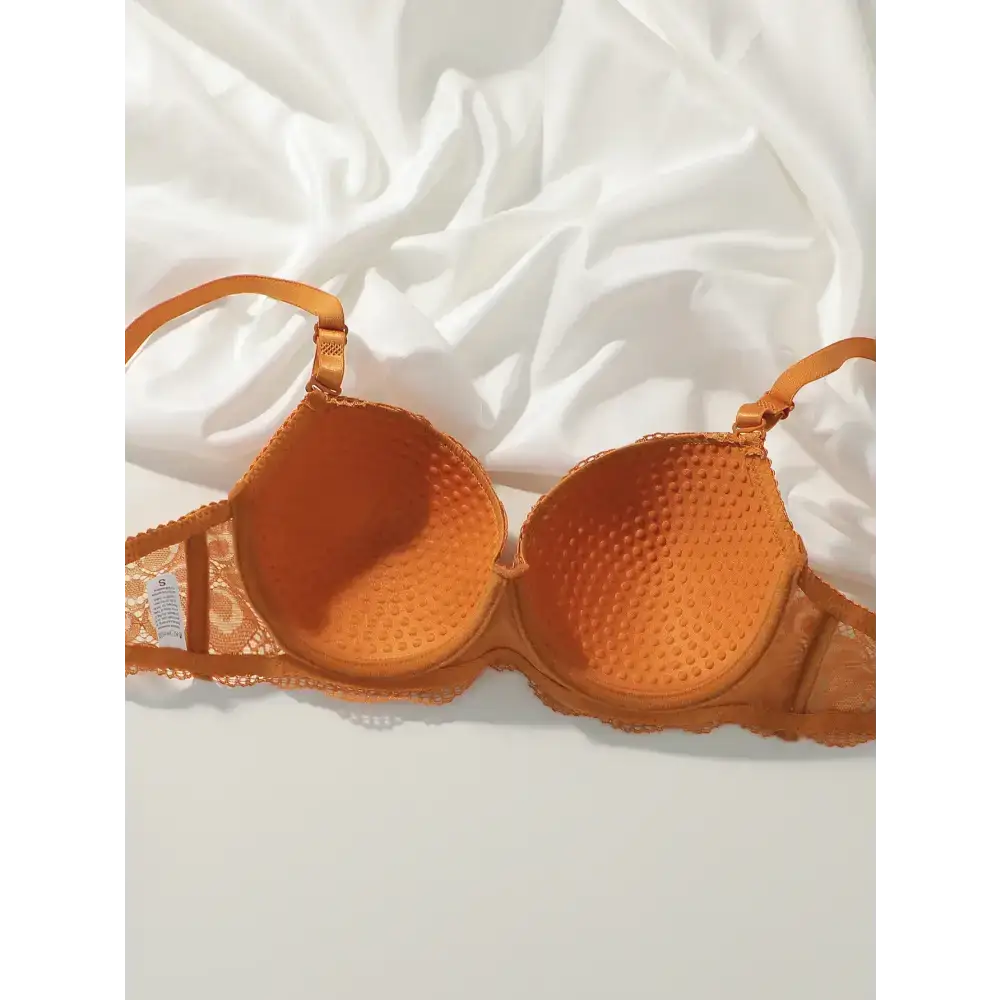 Orange sexy lace bra and panty set featuring textured cups and lace detailing