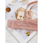 Sexy lingerie embroidered lace bra in soft pink displayed on a marble surface with bread and coffee