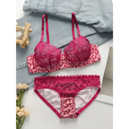 Sexy pink leopard print lingerie set with lace detailing displayed on a white surface