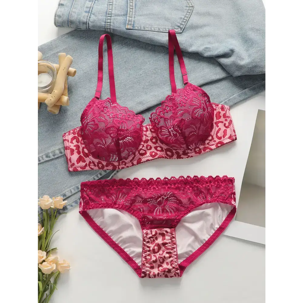 Sexy pink leopard print lingerie set with lace detailing displayed on a white surface