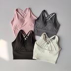 Shockproof crop top for women available in pink, grey, black, and white with stylish cross-back design