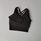 Elegant black shockproof crop top for women with stylish crisscross strap design