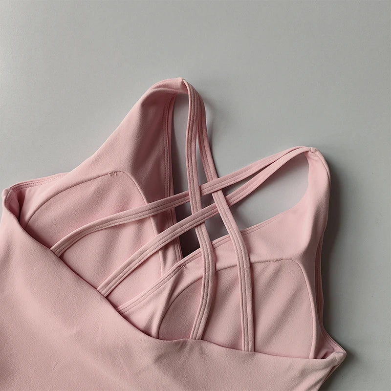 Pink shockproof crop top for women with stylish crisscross straps and soft fabric design