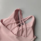 Pink shockproof crop top for women with stylish crisscross straps and soft fabric design