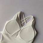 Stylish white shockproof crop top for women with crisscross straps for a trendy look