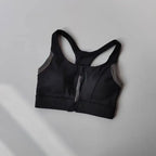 Shockproof padded gym bra for women with a zip front and supportive design in black