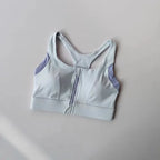 Light blue shockproof padded gym bra for women with adjustable straps and back zip closure