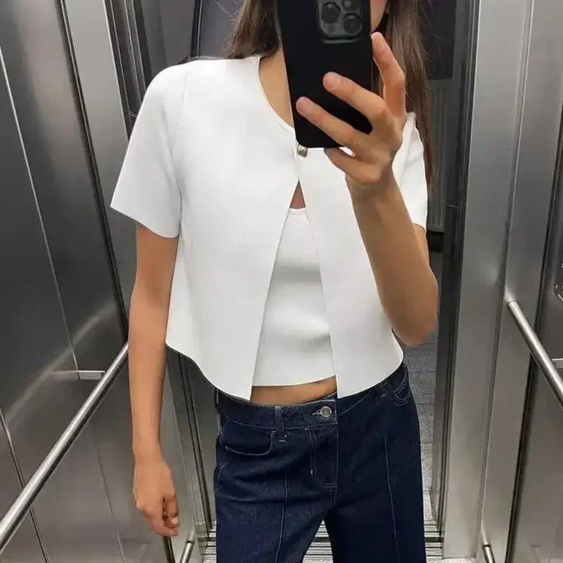 White casual fashion cropped jacket with short sleeves worn by woman in elevator selfie