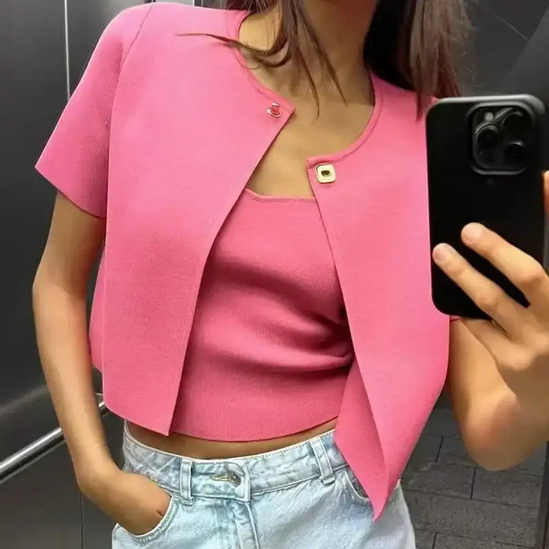 Pink casual fashion cropped jacket with short sleeves worn over matching tank top and light denim jeans