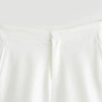 Close-up of white shorts waistband with button for summer office vest and shorts outfit