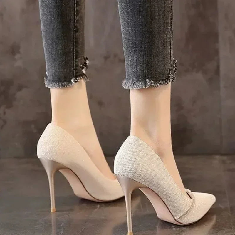 Beige single strap stiletto heels with pointed toe worn with frayed hem jeans
