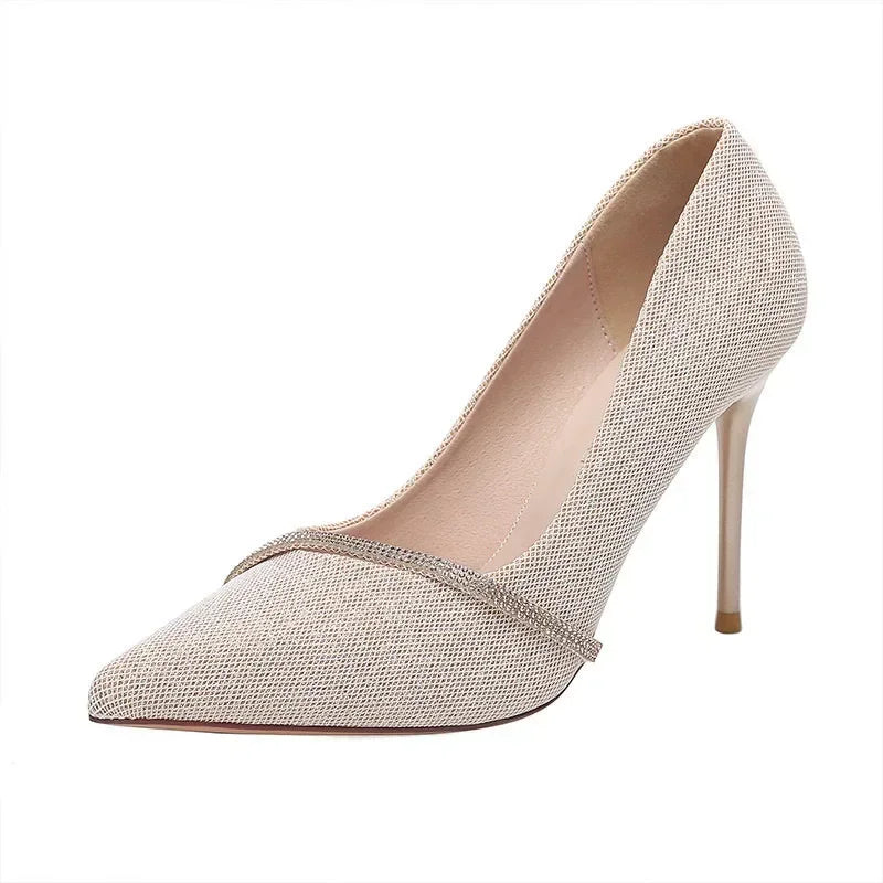 Beige single strap stiletto heels with pointed toe and textured fabric from The Lady's Haven Boutique