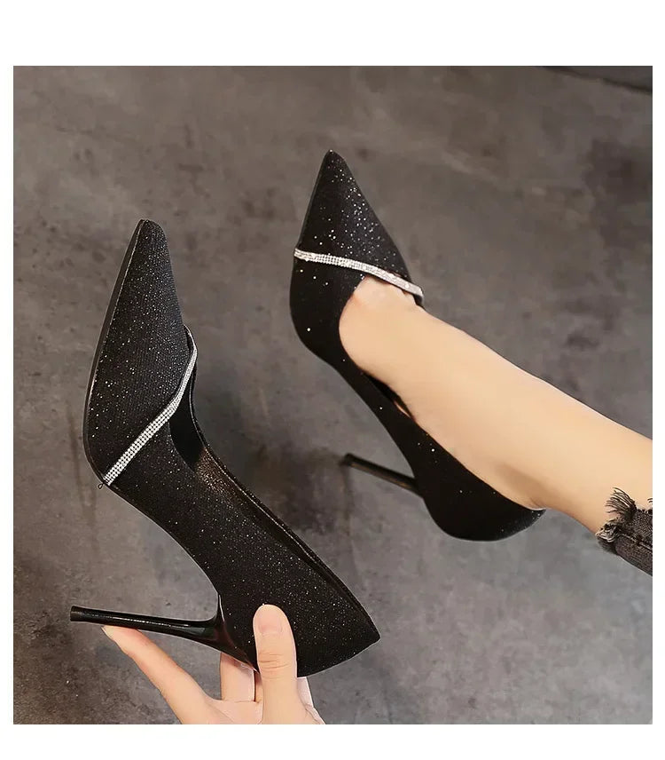 Black single strap stiletto heels with glitter finish and rhinestone trim for elegant wear