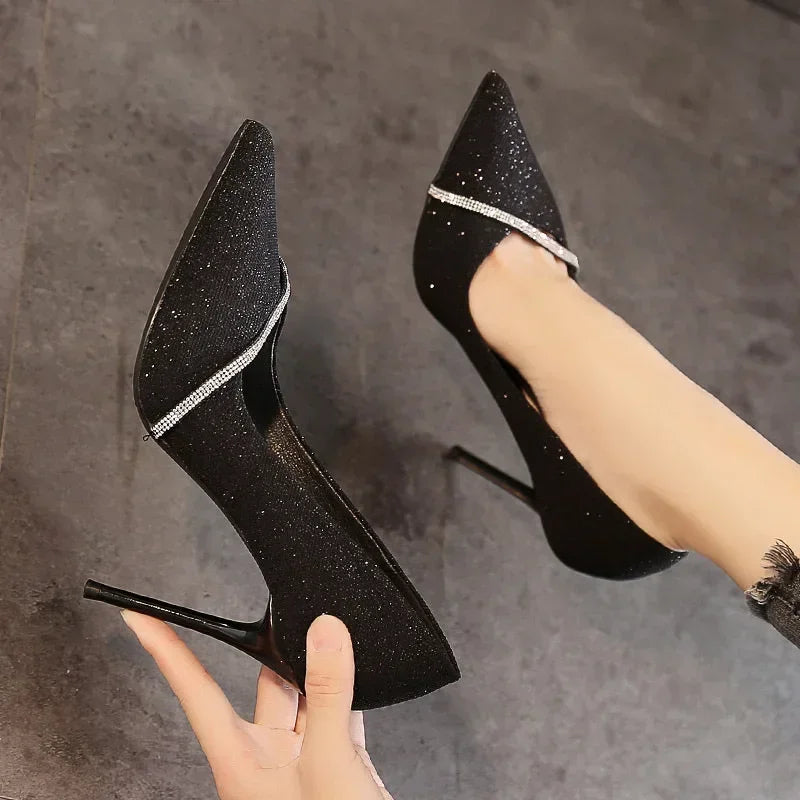 Black single strap stiletto heels with glitter finish and rhinestone detail from The Lady's Haven Boutique