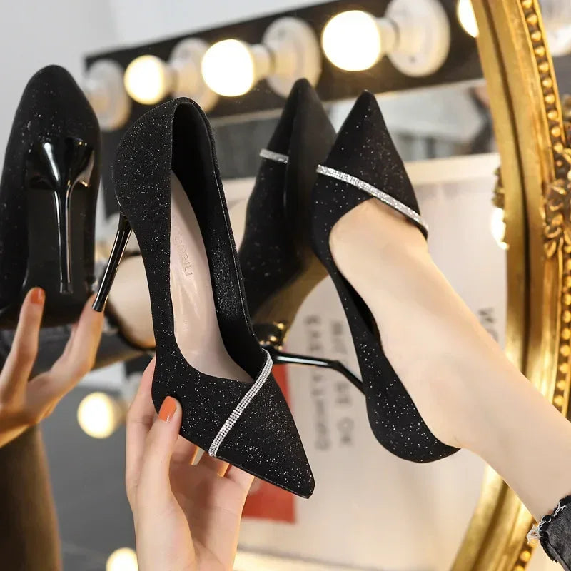 Black glitter single strap stiletto heels with pointed toe and rhinestone detail from The Lady's Haven Boutique