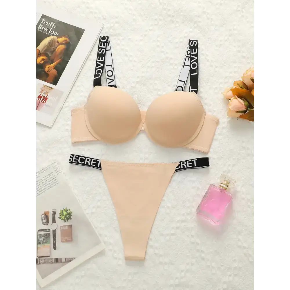 Beige small chest lifting underwear set with black and white straps from The Lady's Haven Boutique