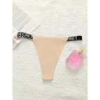 Beige thong underwear with black elastic waistband featuring SECRET text for small chest lifting underwear