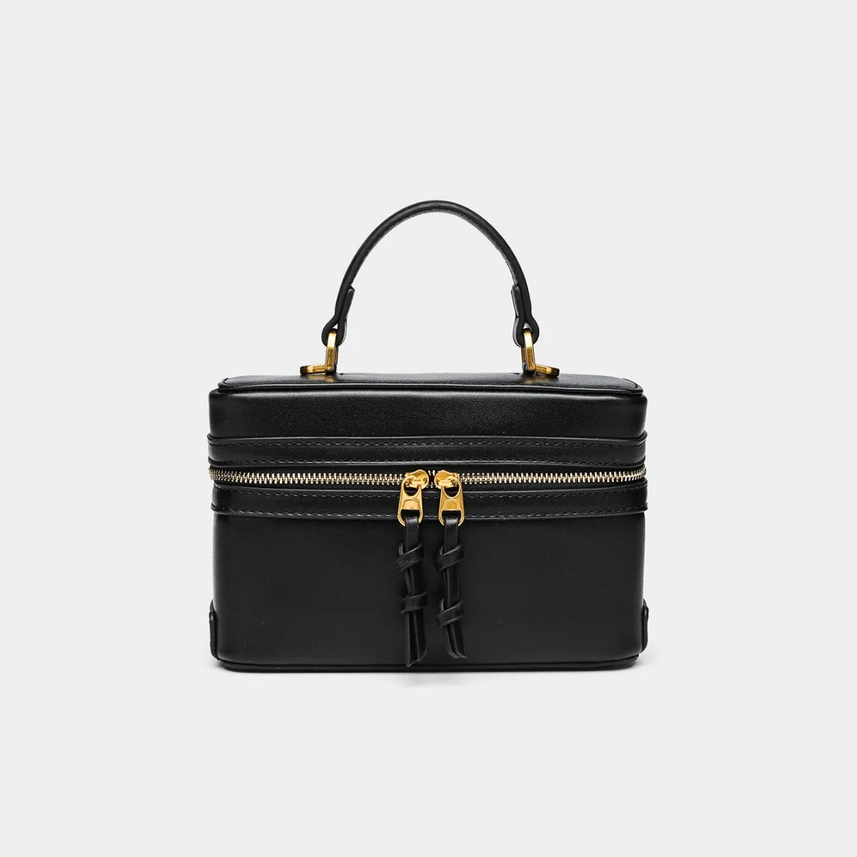 Black small square bag with gold zipper and top handle from The Lady's Haven Boutique