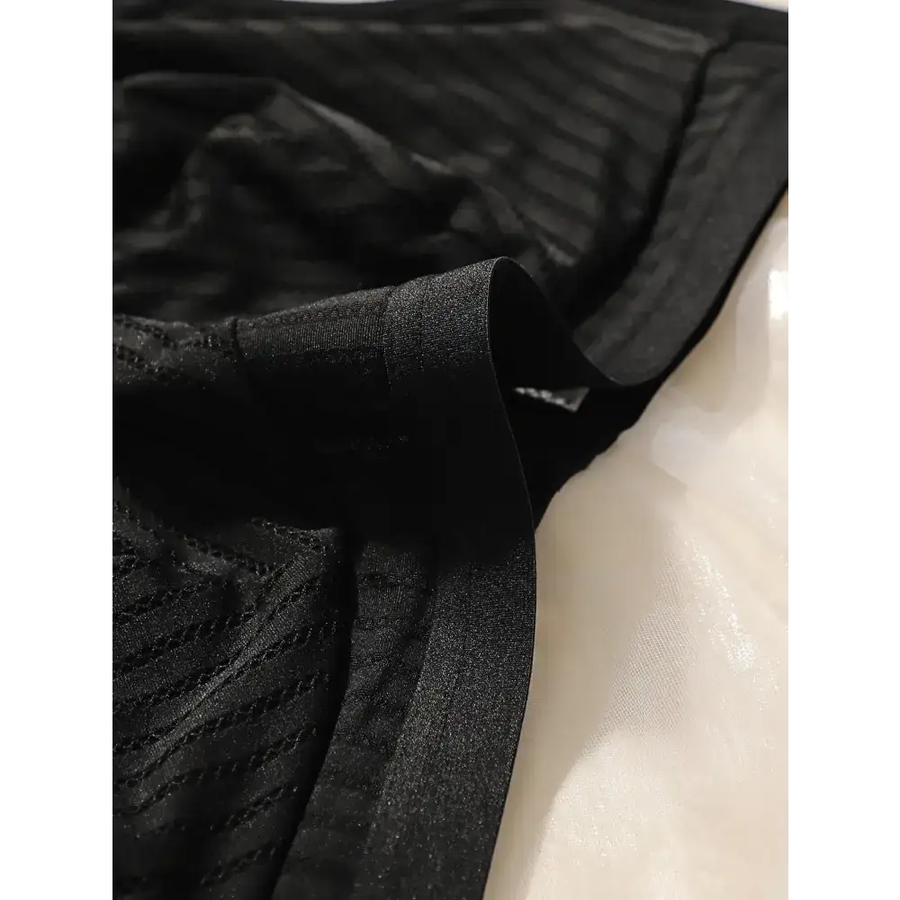 Black solid color striped plus size lingerie fabric close up showing texture and waistband detail