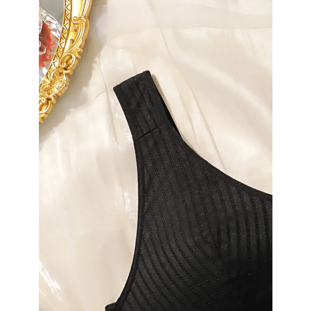 Black solid color striped plus size lingerie bra strap and cup detail on white fabric