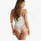 Back view of woman wearing white spaghetti strap sexy lace bodysuit with lace detailing
