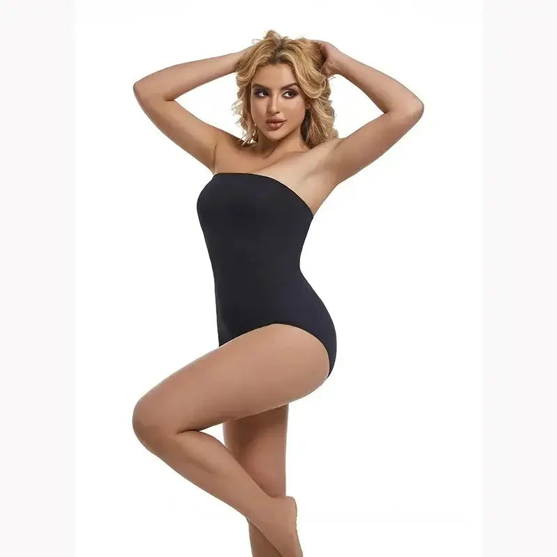 Black strapless shapewear bodysuit modeled by woman with hands behind head from The Lady's Haven Boutique