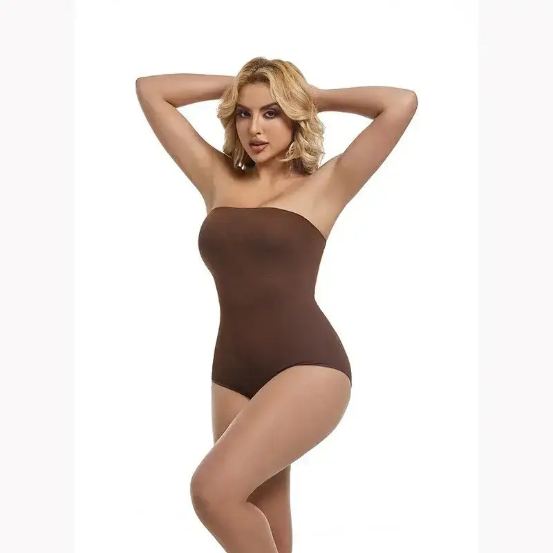 Woman wearing a brown strapless shapewear bodysuit from The Lady's Haven Boutique posing with hands behind head