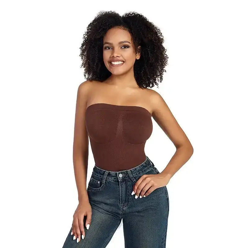 Model wearing a brown strapless thong bodysuit for women paired with high-waisted jeans