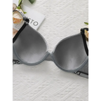 Striped adjustable push up bra from The Lady's Haven Boutique laid flat on white textured surface
