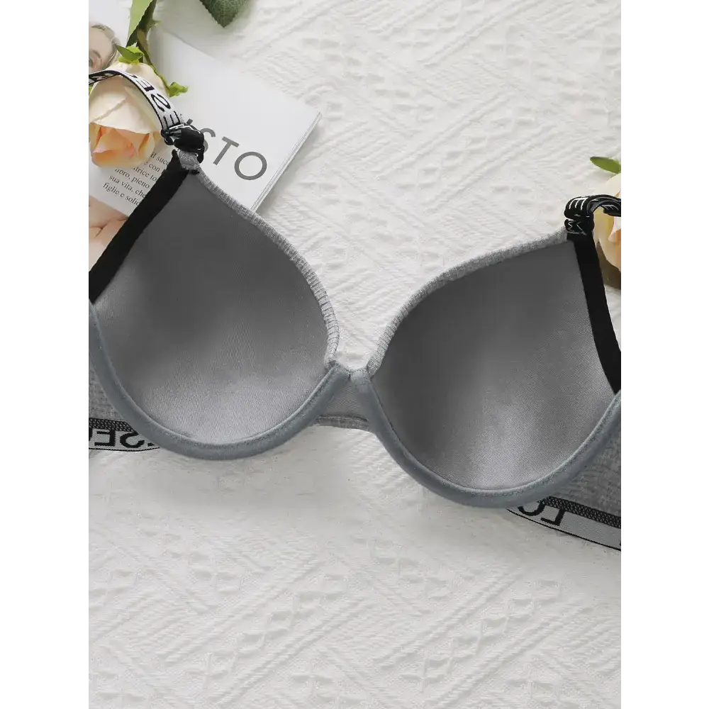 Striped adjustable push up bra from The Lady's Haven Boutique laid flat on white textured surface